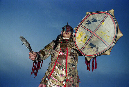 A Nganasan shaman with a tambourine performs a rite of worship.  Taimyr.